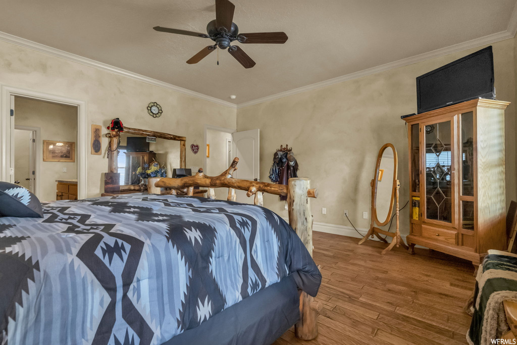 Bedroom featuring ornamental molding, light hardwood floors, and ceiling fan
