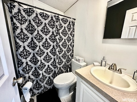 Bathroom featuring vanity, mirror, and a textured ceiling