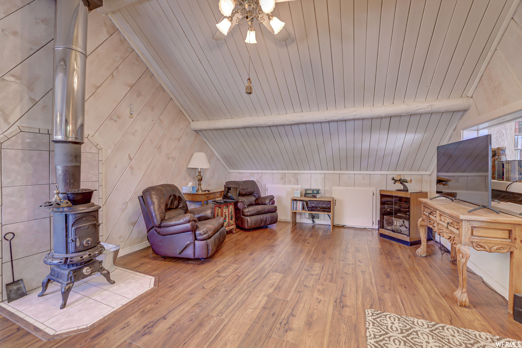 Living room featuring light hardwood / wood-style flooring, wooden ceiling, and vaulted ceiling with beams