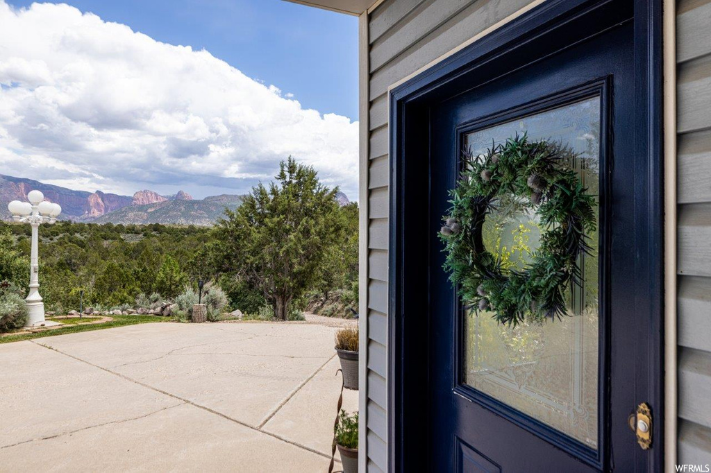Doorway to property with a patio area and a mountain view