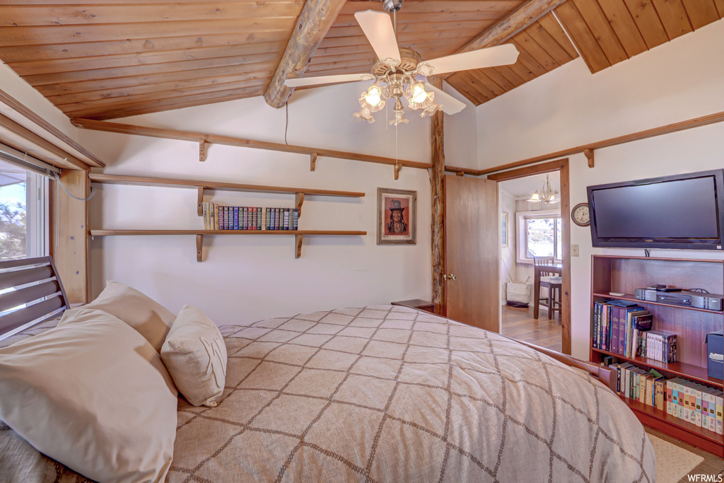 Bedroom with vaulted ceiling with beams, wood ceiling, ceiling fan, and light hardwood / wood-style floors