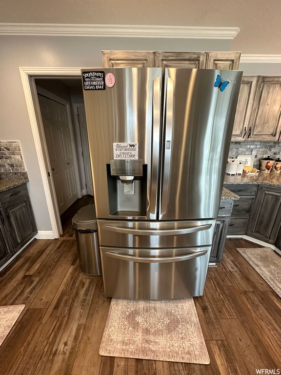 Kitchen featuring crown molding, backsplash, light hardwood floors, and stainless steel fridge with ice dispenser