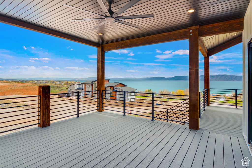 Wooden deck featuring ceiling fan and a water view