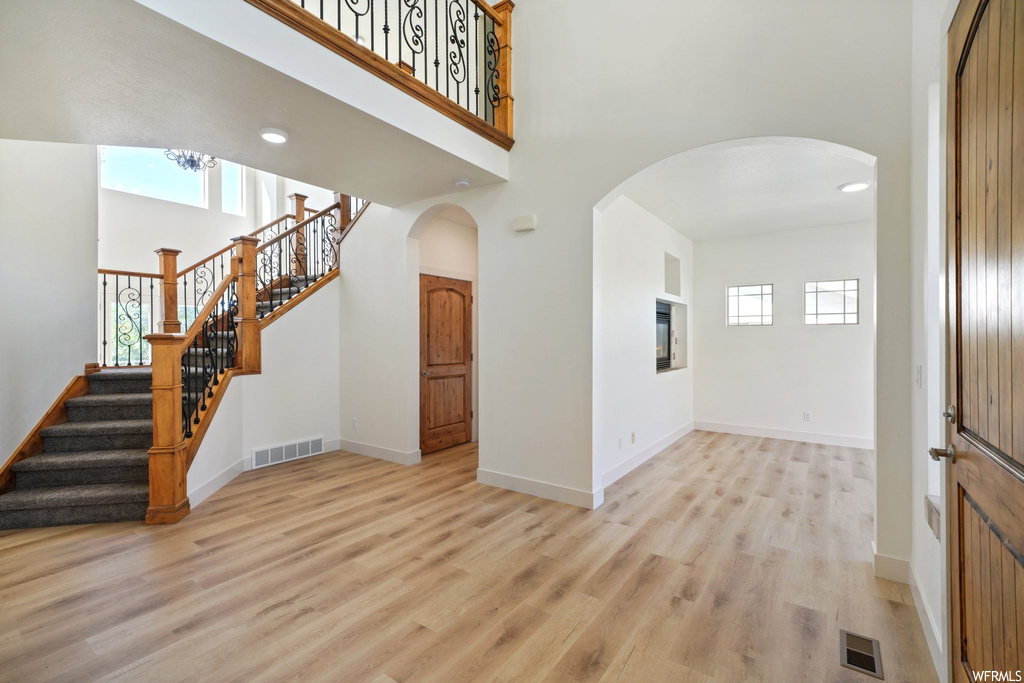 Hardwood floored foyer with a high ceiling