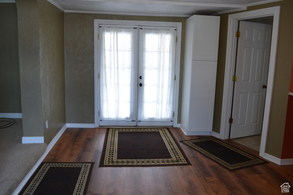 Doorway to outside with dark hardwood / wood-style floors and french doors