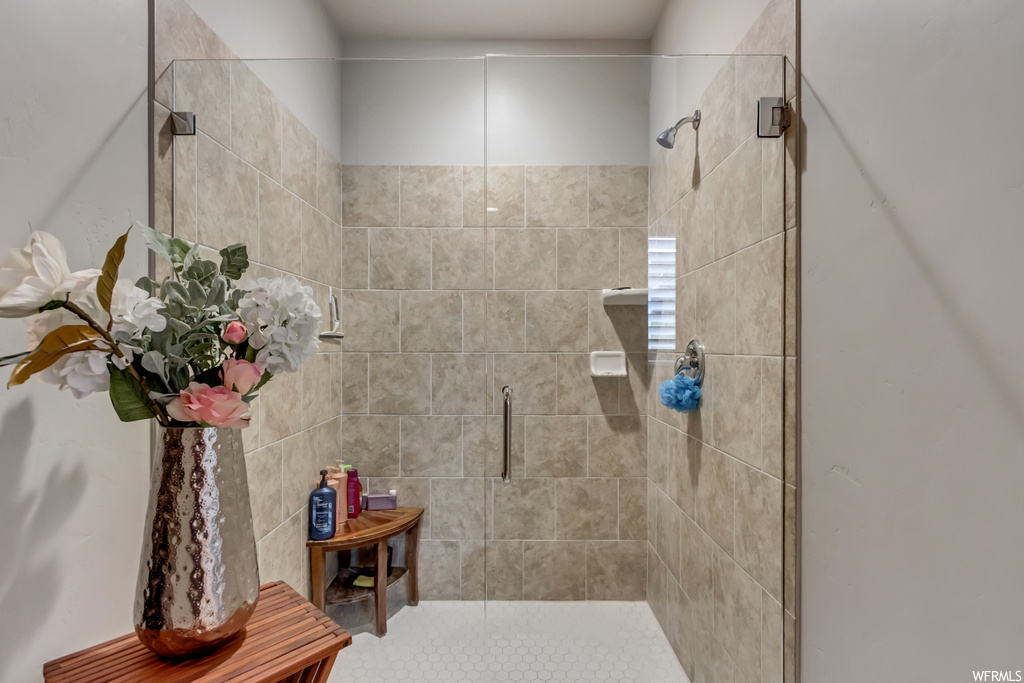 Bathroom featuring a shower with door