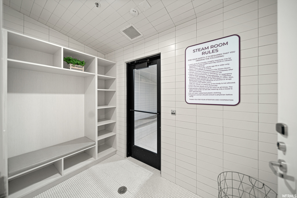 Mudroom featuring lofted ceiling