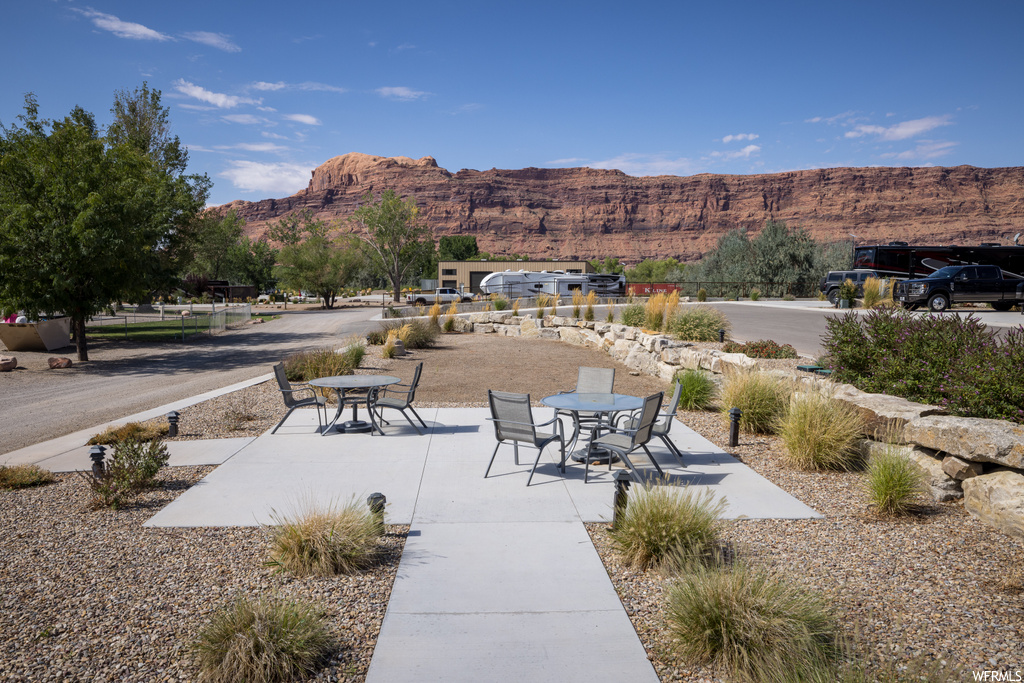 View of home\'s community featuring a mountain view and a patio area