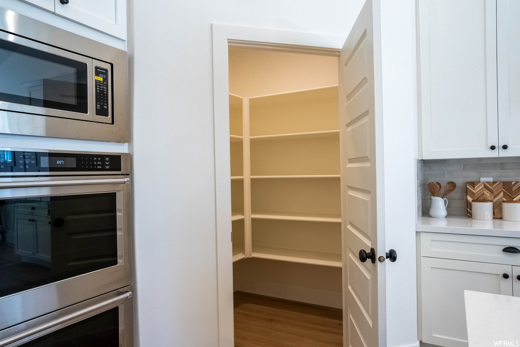 Pantry featuring stacked washer and dryer