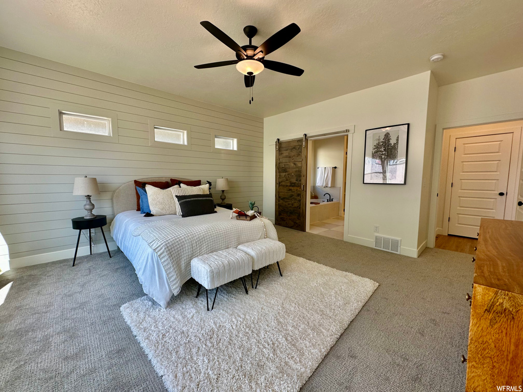 Carpeted bedroom with wooden walls and ceiling fan