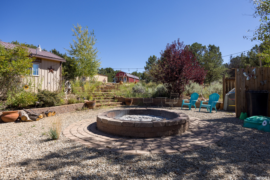 View of yard with a patio and a firepit