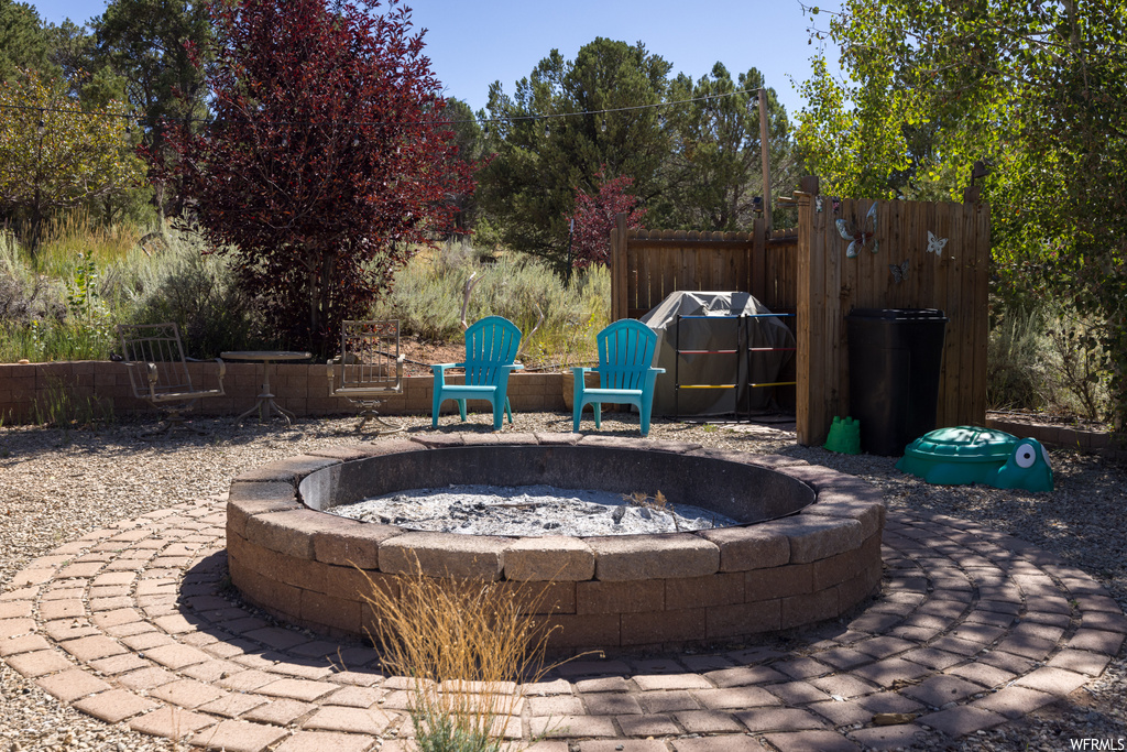 View of terrace featuring an outdoor firepit