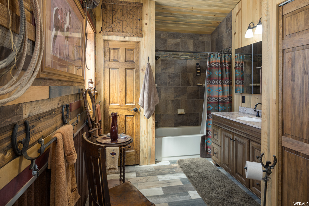 Bathroom with vanity, wooden walls, mirror, hardwood floors, wood ceiling, and shower / bathtub combination with curtain