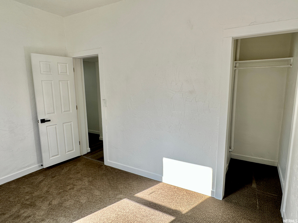Bedroom with dark carpet