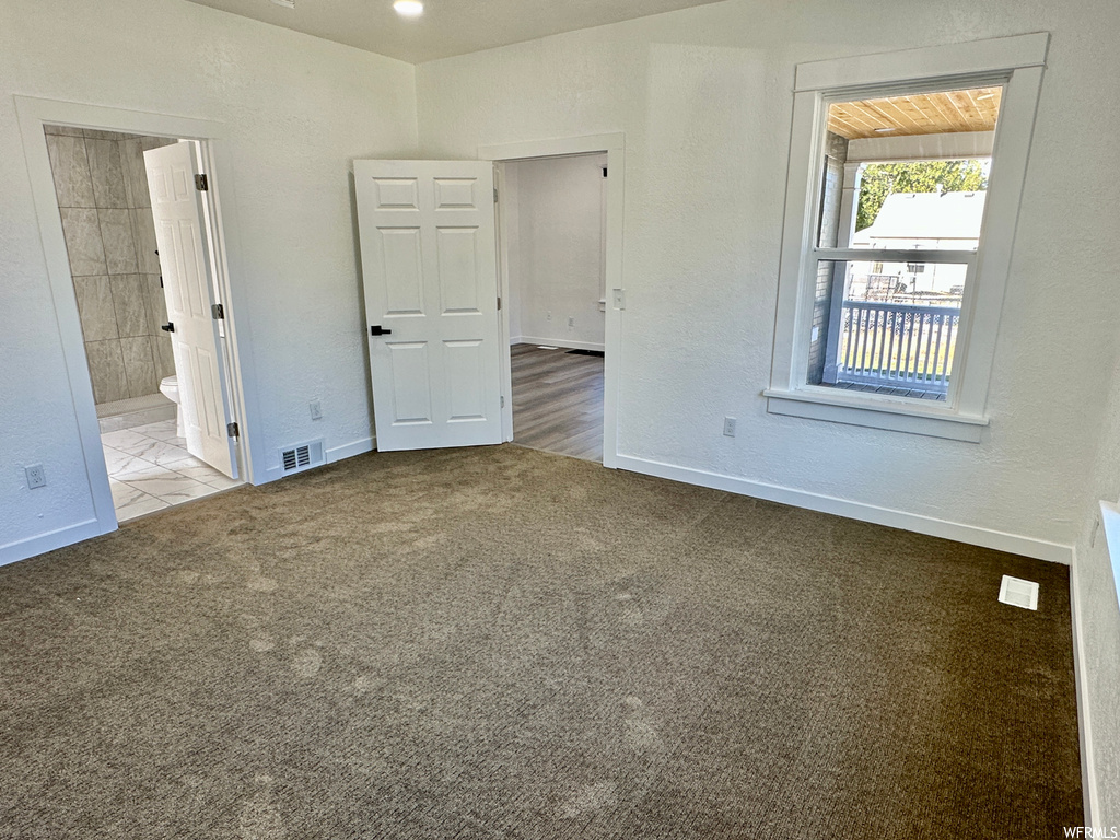 Spare room featuring light carpet
