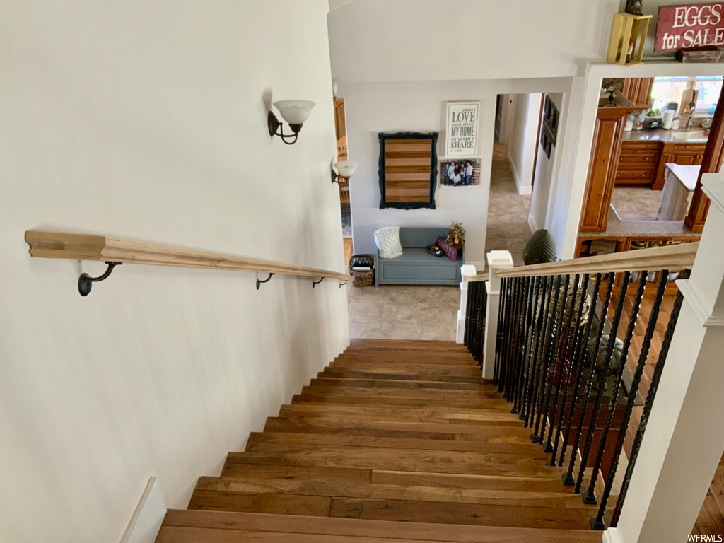 Staircase featuring light hardwood floors