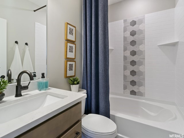 Full bathroom with shower / bath combination with curtain, mirror, and vanity