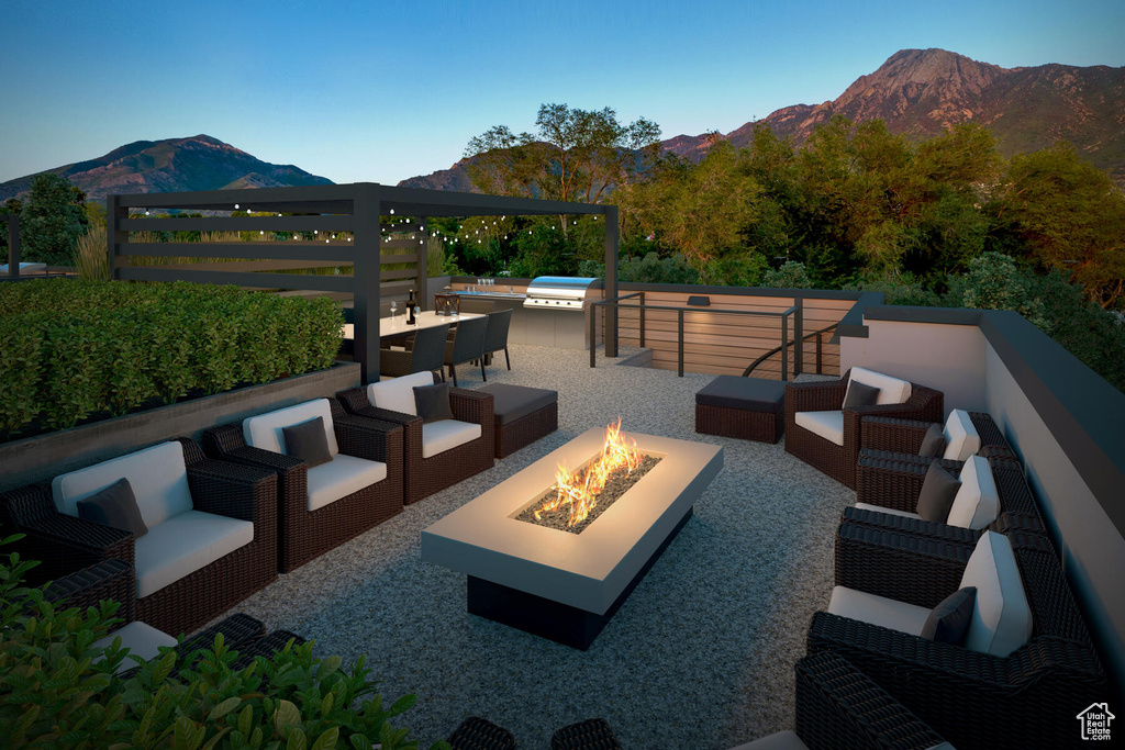 View of patio / terrace with a mountain view and an outdoor living space with a fire pit