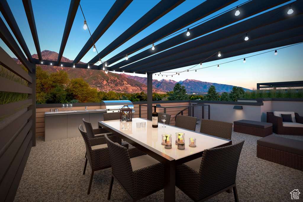 View of patio with a mountain view, a pergola, and grilling area