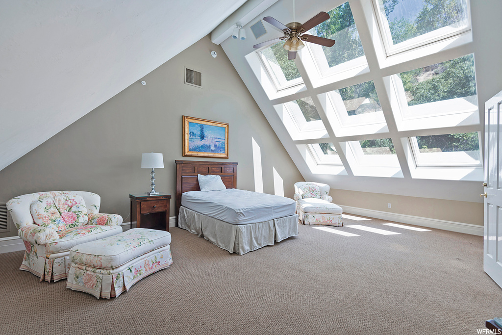 Carpeted bedroom with lofted ceiling with beams, a high ceiling, and ceiling fan