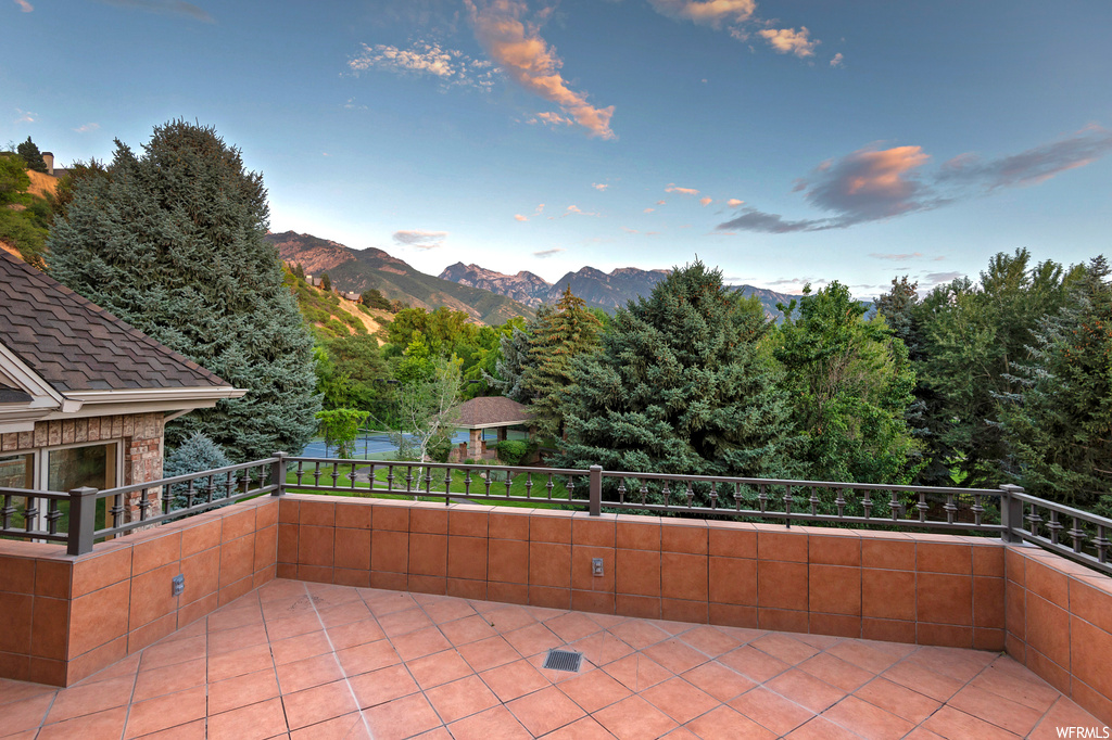 View of patio / terrace with balcony and a mountain view
