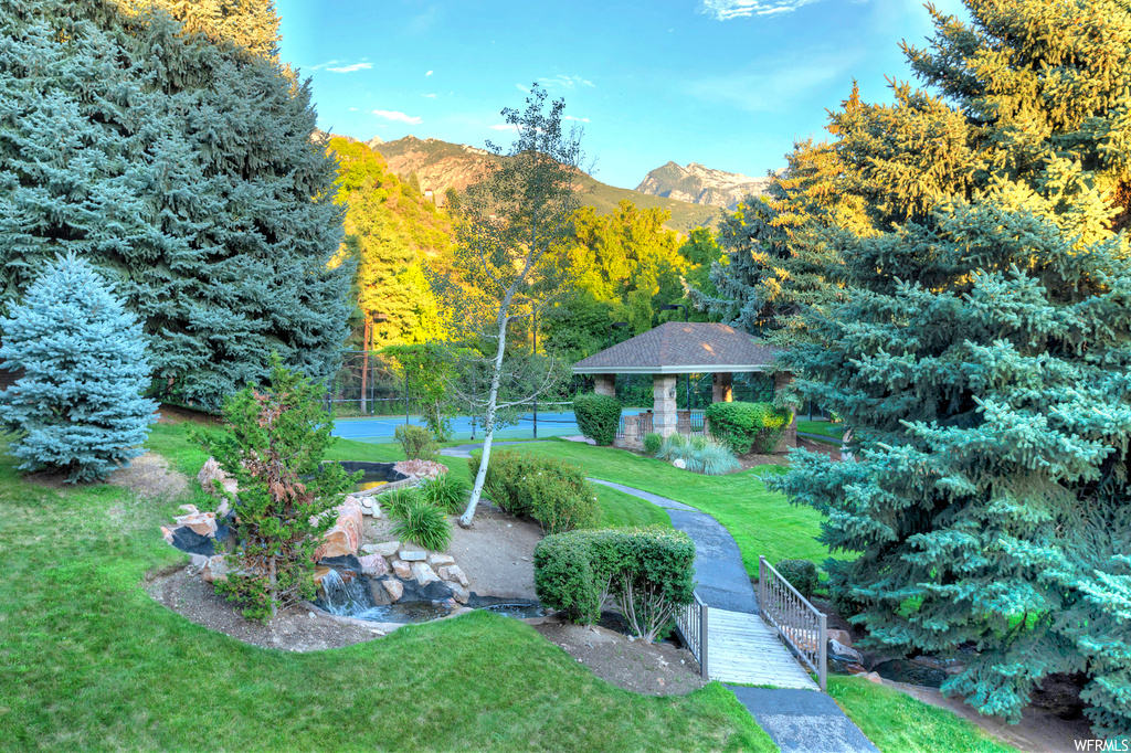 Surrounding community with a mountain view, a lawn, and a gazebo