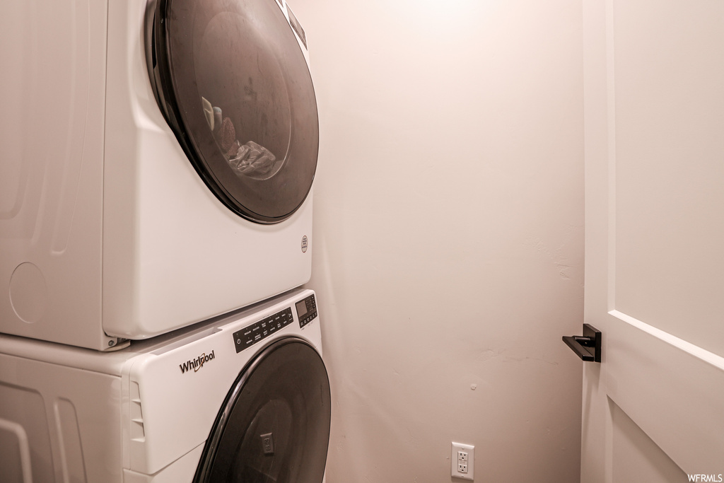 Clothes washing area featuring stacked washer / dryer