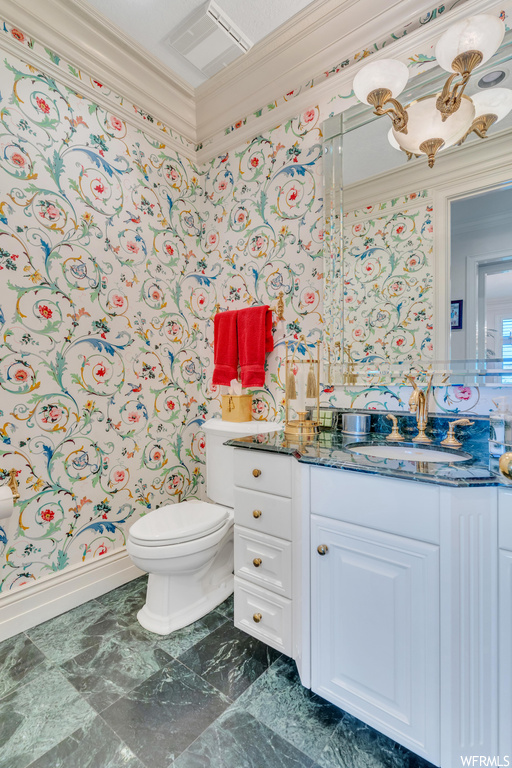 Bathroom with tile floors, ornamental molding, large vanity, and mirror