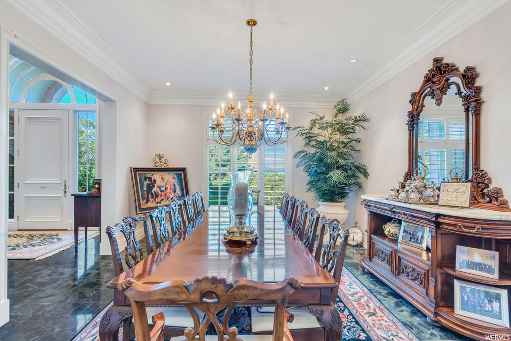 Tiled dining space with a chandelier and crown molding