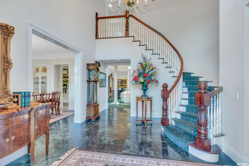 Foyer with a high ceiling and light tile floors