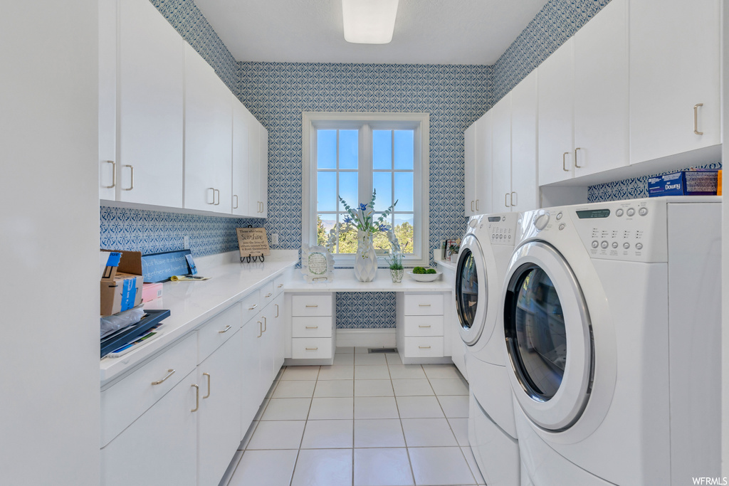 Washroom with independent washer and dryer and light tile floors