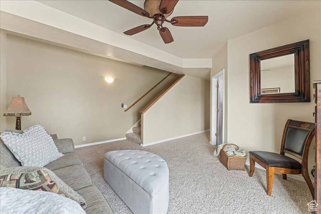 Living room featuring light carpet and ceiling fan