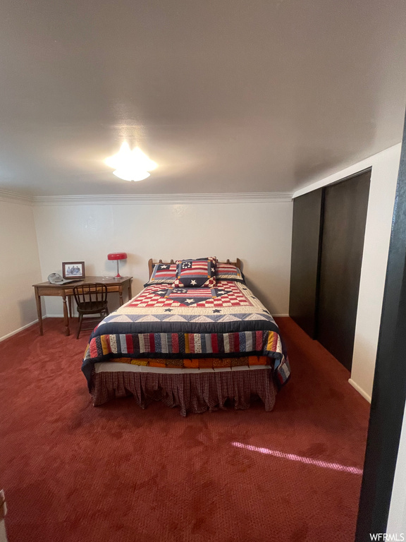 Carpeted bedroom featuring ornamental molding
