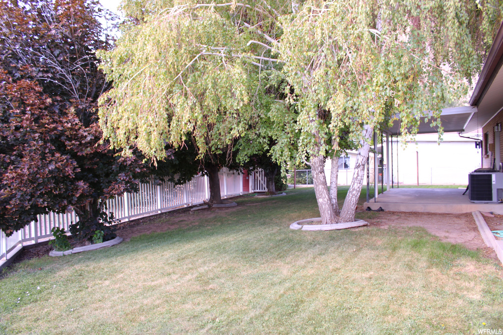 View of yard with central AC