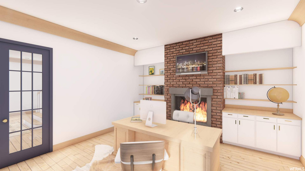 Interior space with light countertops, a fireplace, brick wall, and light hardwood floors