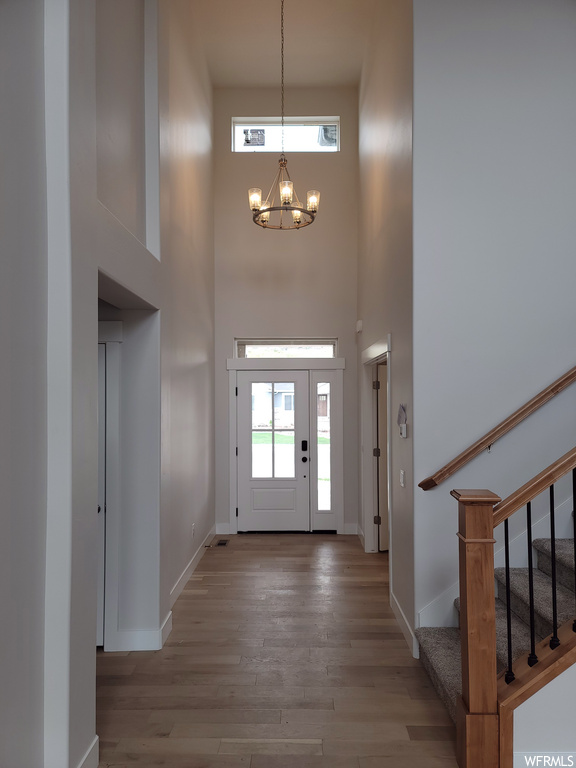 Entrance foyer featuring a high ceiling and light hardwood flooring