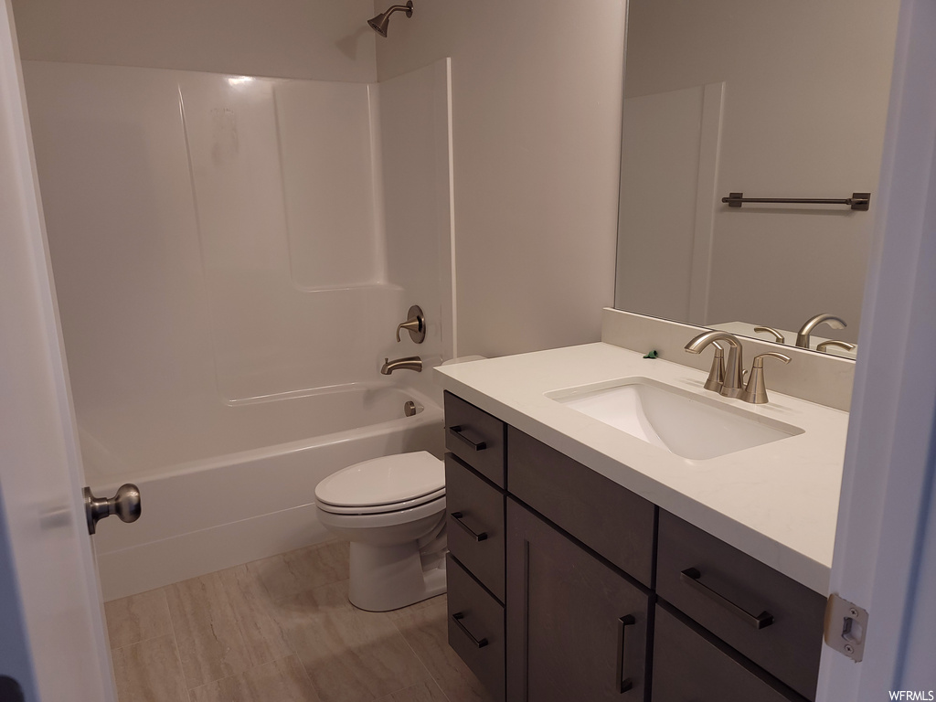 Full bathroom featuring vanity with extensive cabinet space, shower / tub combination, and mirror