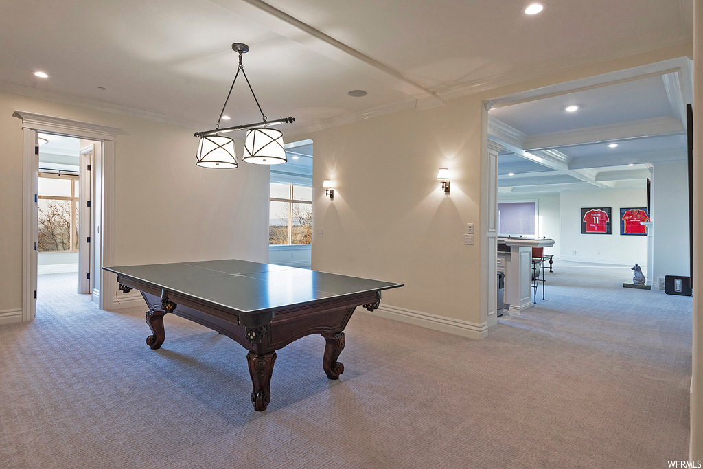 Recreation room with ornamental molding, coffered ceiling, light carpet, and beamed ceiling