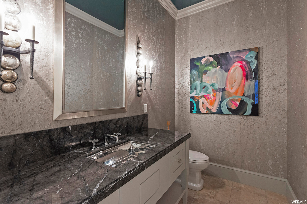 Bathroom with crown molding, tile floors, large vanity, and mirror