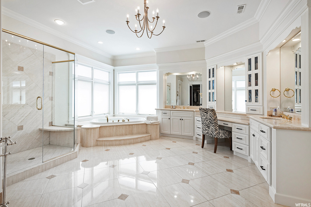 Bathroom with a notable chandelier, vanity, mirror, independent shower and bath, ornamental molding, and light tile floors