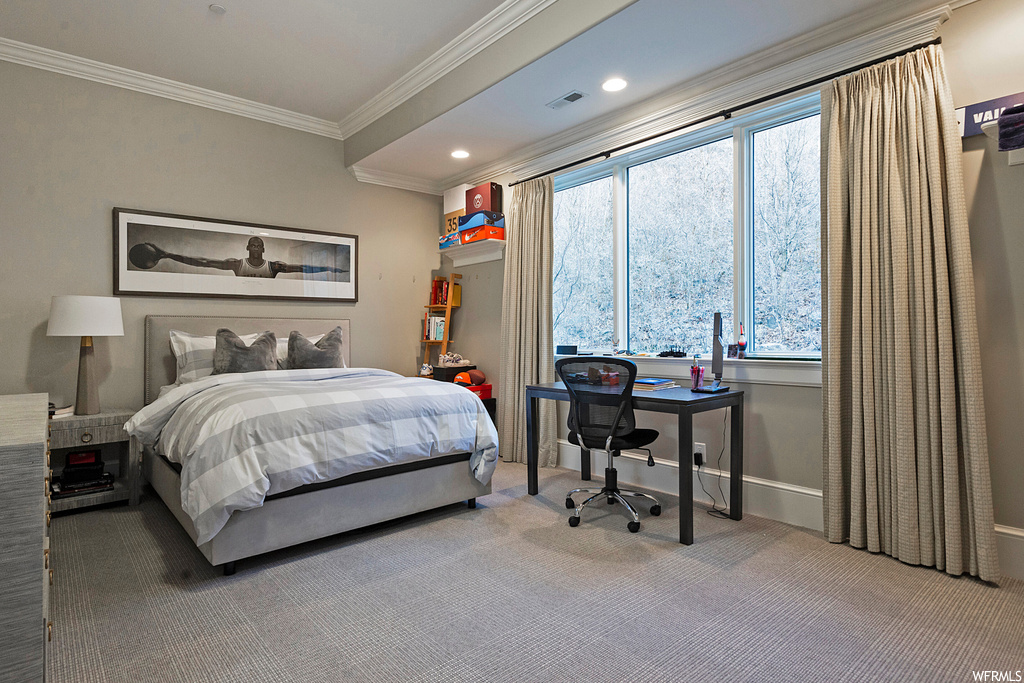 Bedroom featuring crown molding and light carpet
