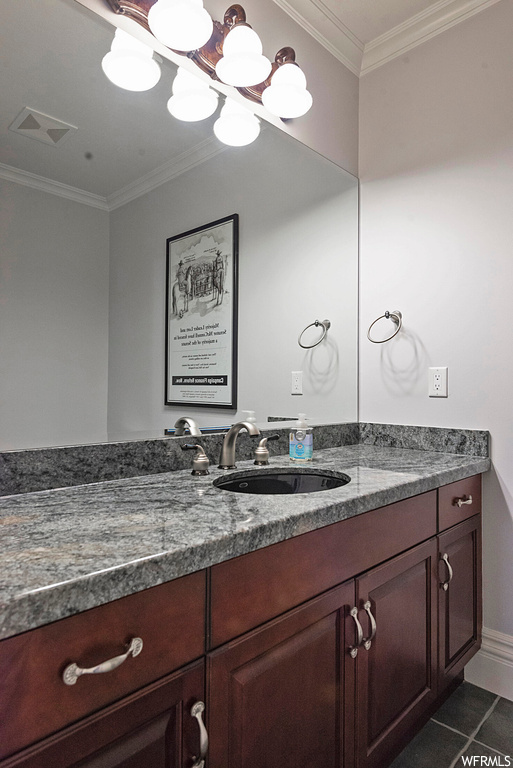 Bathroom featuring crown molding, oversized vanity, tile floors, and mirror