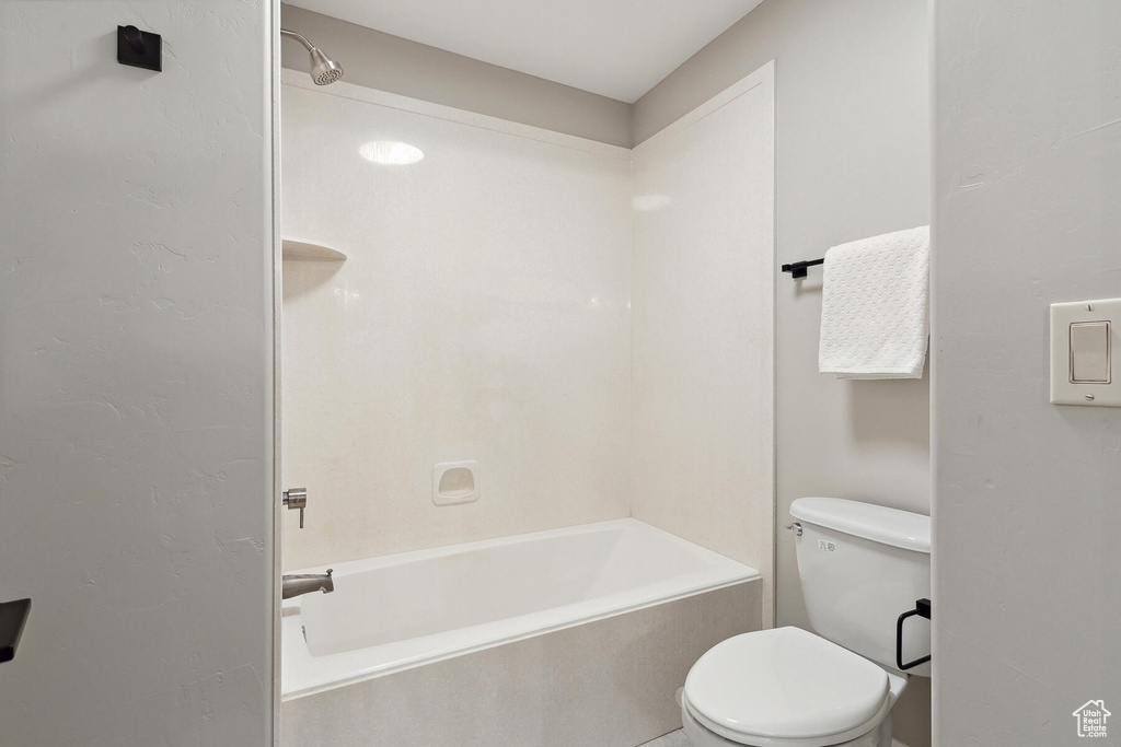 Bathroom featuring toilet and shower / bathtub combination