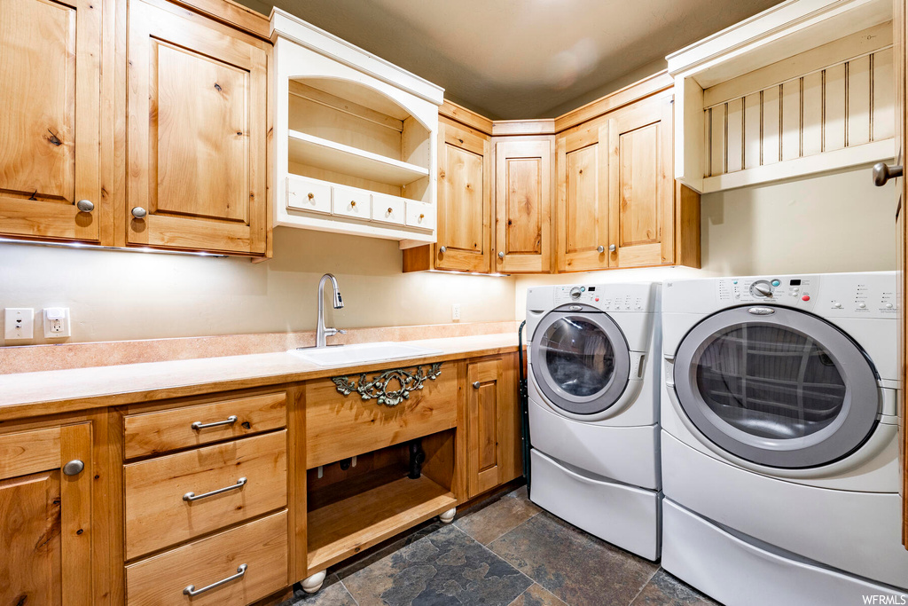 Laundry room featuring tile floors and washing machine and clothes dryer