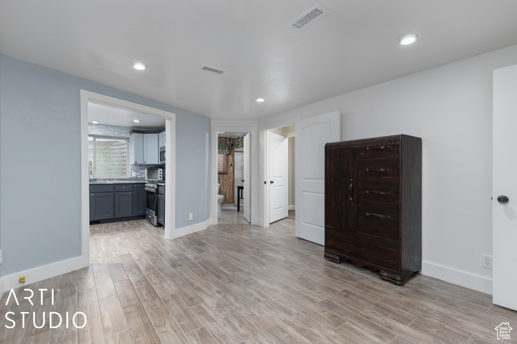 Interior space with light hardwood / wood-style flooring and ensuite bath