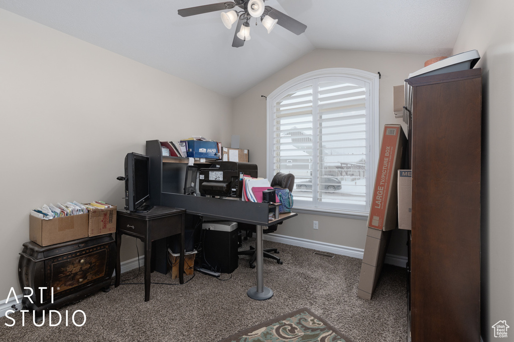 Carpeted home office featuring lofted ceiling and ceiling fan