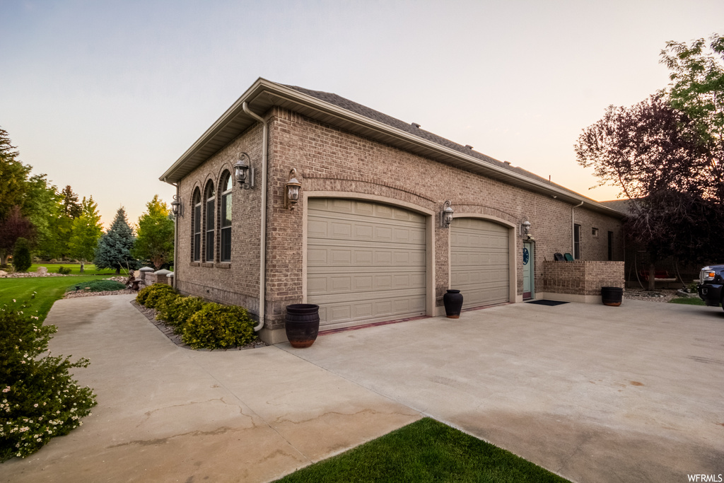 Property exterior at dusk featuring garage