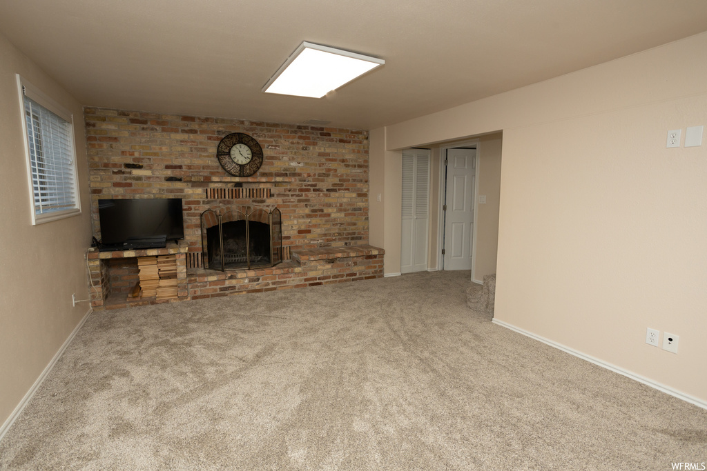 Living room with a fireplace and light carpet