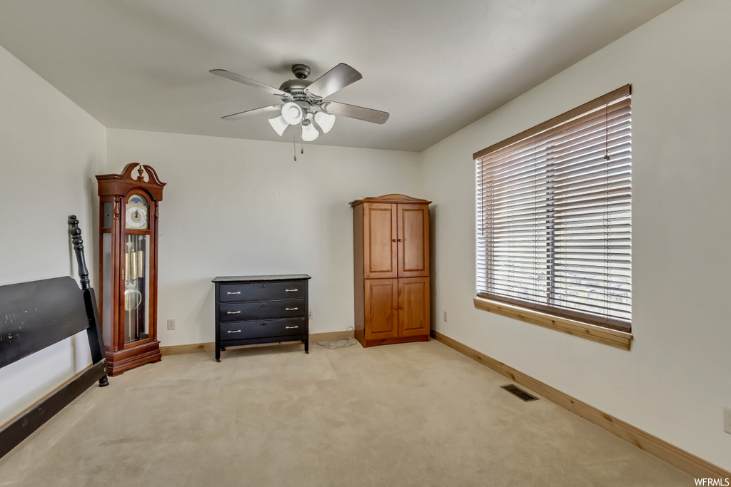 Miscellaneous room featuring light carpet and ceiling fan