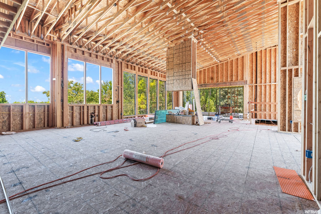 Misc room featuring vaulted ceiling and a high ceiling
